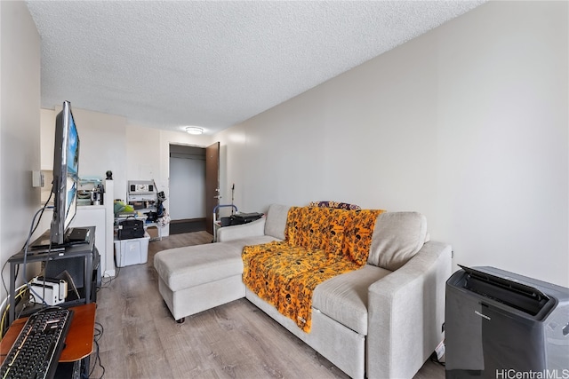 living room with hardwood / wood-style floors and a textured ceiling