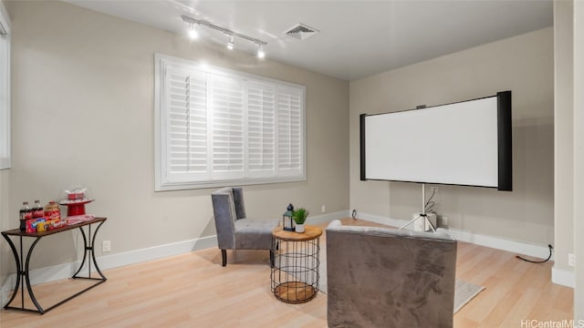 home theater room with light hardwood / wood-style floors