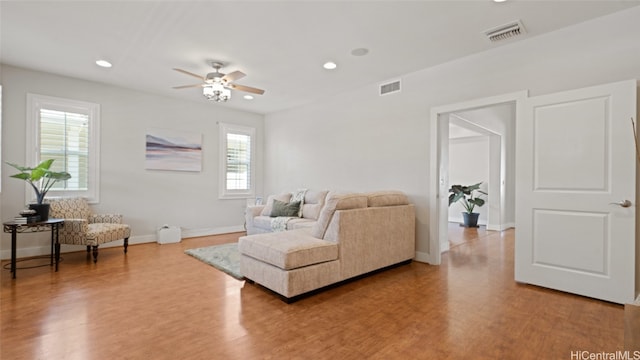 living room with light hardwood / wood-style floors, plenty of natural light, and ceiling fan