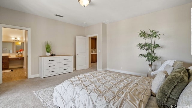 carpeted bedroom featuring ensuite bathroom