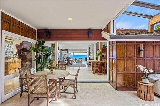 sunroom with a skylight and a water view