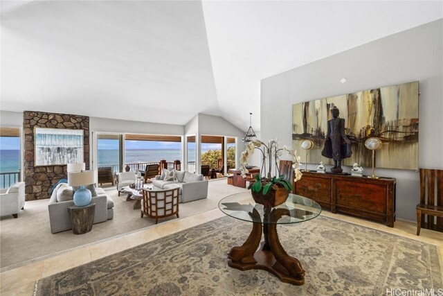 living room with light tile patterned floors, lofted ceiling, and a water view