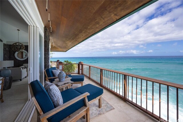 balcony with a water view and a beach view