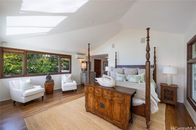 bedroom with vaulted ceiling, a wall mounted AC, and wood-type flooring