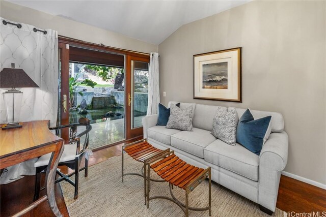 living room with hardwood / wood-style flooring and lofted ceiling