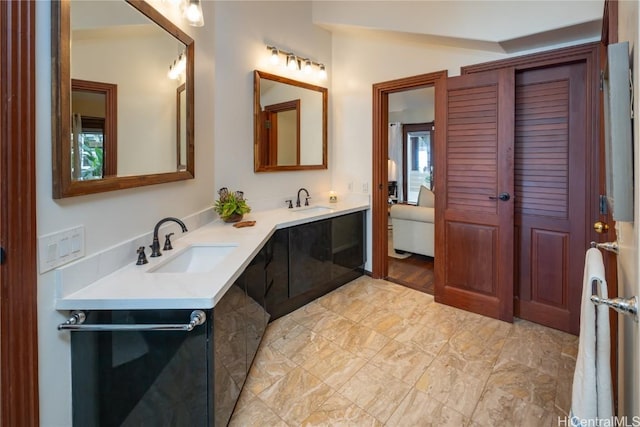 bathroom featuring vanity and lofted ceiling