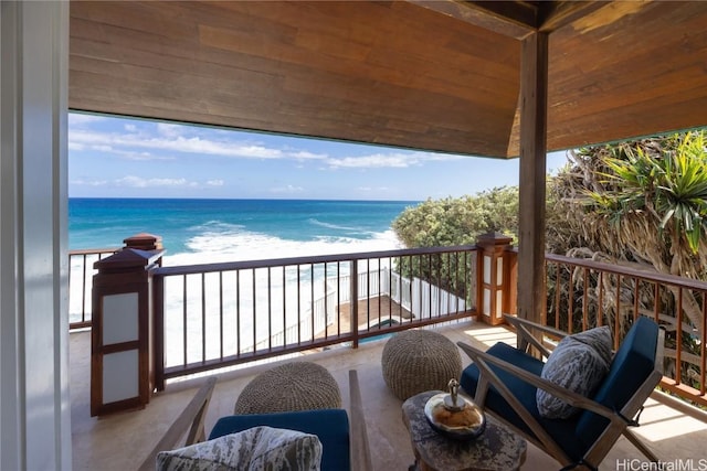 balcony featuring a water view and a view of the beach