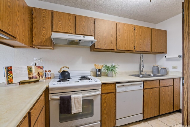 98-501 Koauka Loop Unit A603, Aiea, HI 96701 - kitchen with white appliances, under cabinet range hood, a sink, light countertops, and brown cabinets