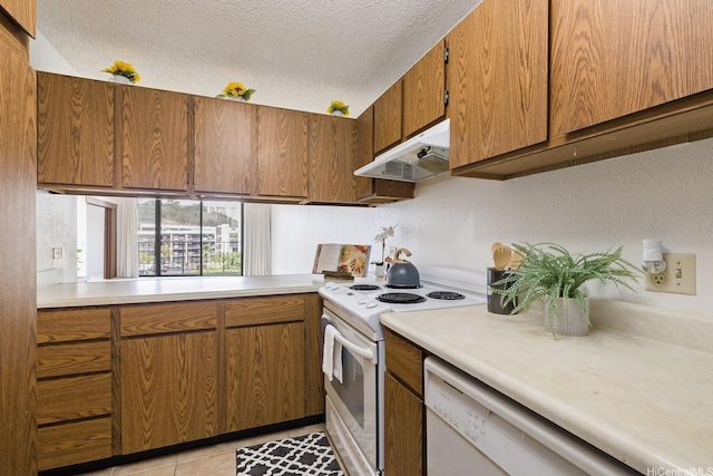 98-501 Koauka Loop Unit A603, Aiea, HI 96701 - kitchen featuring white appliances, under cabinet range hood, a textured ceiling, light countertops, and brown cabinets