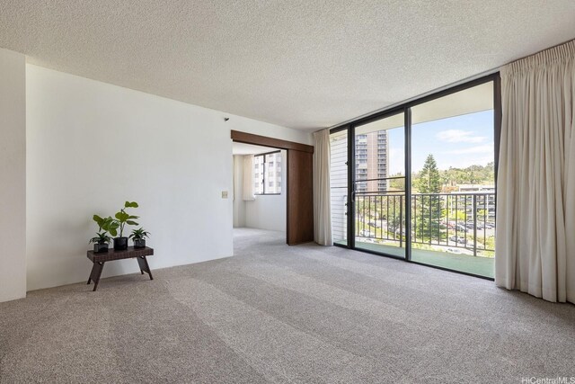 98-501 Koauka Loop Unit A603, Aiea, HI 96701 - spare room with carpet flooring, expansive windows, and a textured ceiling