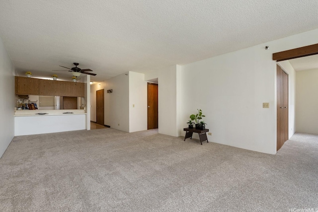 98-501 Koauka Loop Unit A603, Aiea, HI 96701 - unfurnished living room with light colored carpet, ceiling fan, and a textured ceiling