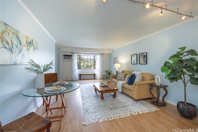 living room featuring a wall mounted AC, light hardwood / wood-style floors, and crown molding