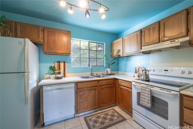 kitchen with white appliances, sink, light tile patterned floors, and track lighting