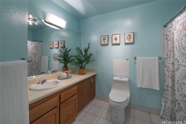 bathroom featuring toilet, vanity, tile patterned flooring, and curtained shower