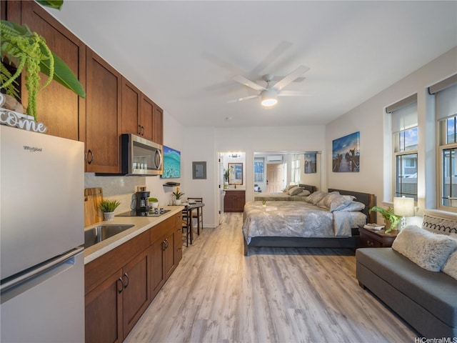 84-883 Maiola St Unit 118, Waianae, HI 96792 - bedroom with freestanding refrigerator and light wood-type flooring