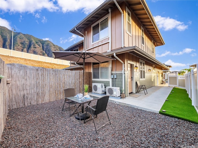 84-883 Maiola St Unit 118, Waianae, HI 96792 - back of house with board and batten siding, a patio, a fenced backyard, and a mountain view