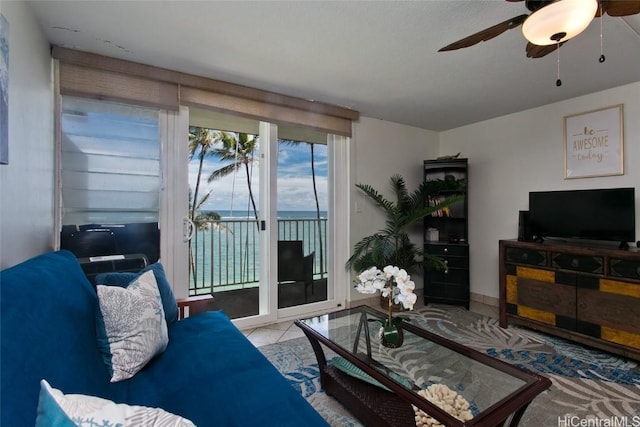 living area featuring ceiling fan and light tile patterned flooring