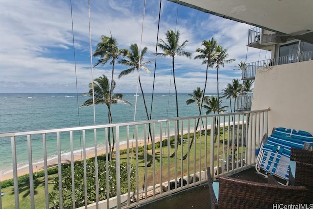 balcony featuring a water view and a view of the beach