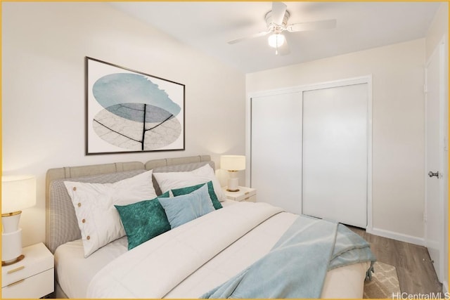 bedroom featuring hardwood / wood-style floors, ceiling fan, and a closet