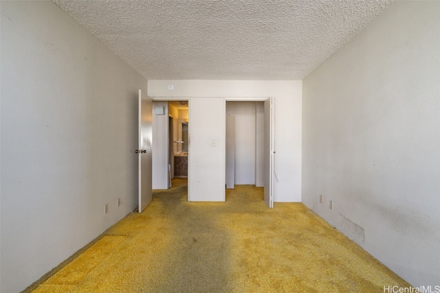 unfurnished bedroom with carpet flooring and a textured ceiling