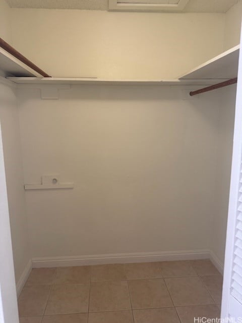 walk in closet featuring light tile patterned flooring