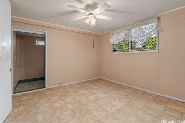 empty room with crown molding, plenty of natural light, and ceiling fan