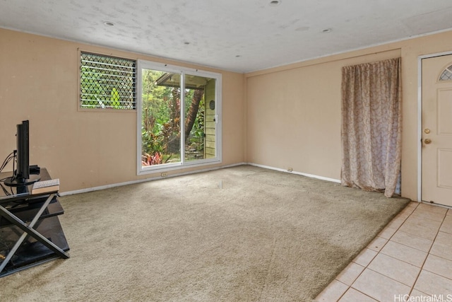 interior space featuring light tile patterned flooring and a textured ceiling