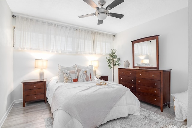 bedroom with ceiling fan and light wood-type flooring