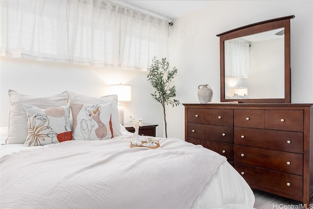 bedroom featuring hardwood / wood-style floors and multiple windows