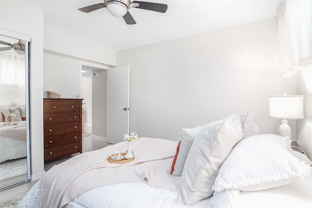 bedroom with hardwood / wood-style floors and ceiling fan