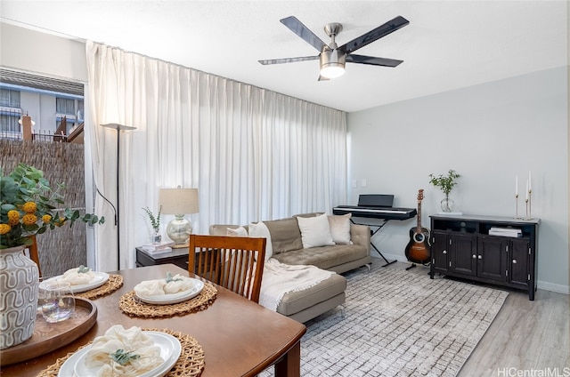 living room with ceiling fan and light hardwood / wood-style floors