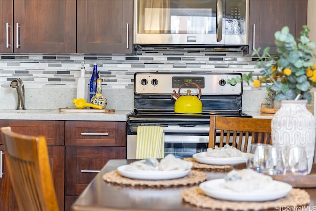 kitchen with backsplash, sink, and stainless steel appliances