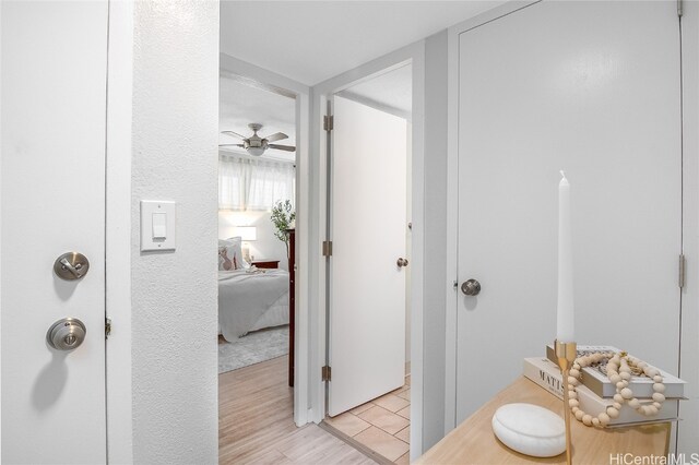 bathroom with hardwood / wood-style flooring and ceiling fan