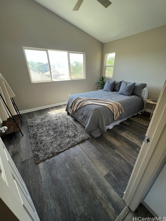 bedroom featuring ceiling fan, dark hardwood / wood-style flooring, and vaulted ceiling