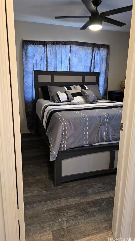 bedroom with hardwood / wood-style floors and ceiling fan