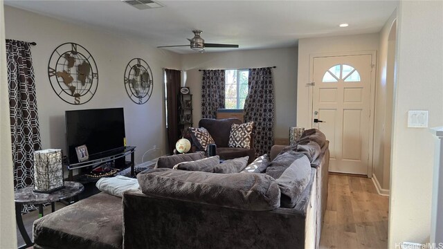 living room with ceiling fan and light wood-type flooring