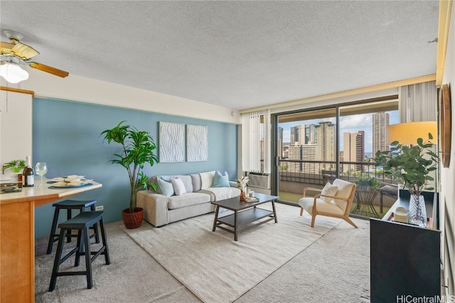 carpeted living room featuring ceiling fan, a textured ceiling, and cooling unit