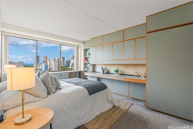 bedroom with light carpet and a textured ceiling