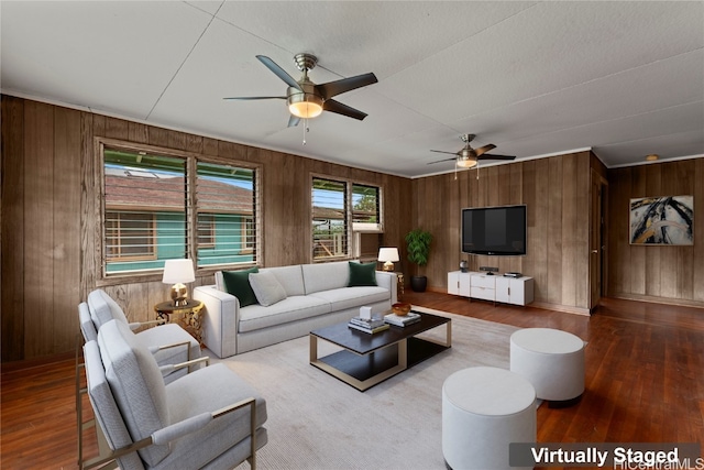 living room with wood walls, hardwood / wood-style flooring, and ceiling fan