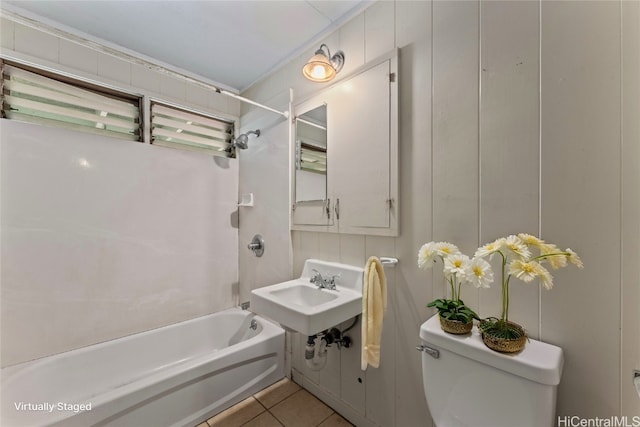 full bathroom featuring toilet, bathtub / shower combination, sink, and tile patterned floors