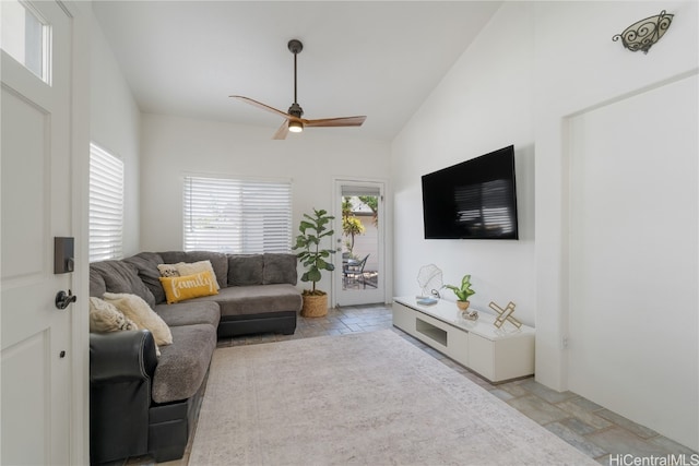 living room featuring ceiling fan and lofted ceiling