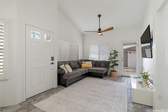 living room with ceiling fan and high vaulted ceiling