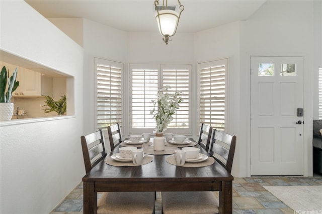 91-1061 Kaileolea Dr Unit 2C1, Ewa Beach, HI 96706 - dining area featuring light stone finish floors and plenty of natural light