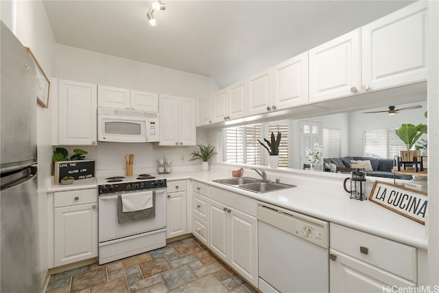 kitchen featuring white appliances, white cabinets, a wealth of natural light, and sink