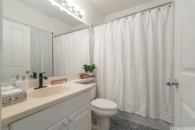 bathroom featuring toilet, walk in shower, and vanity