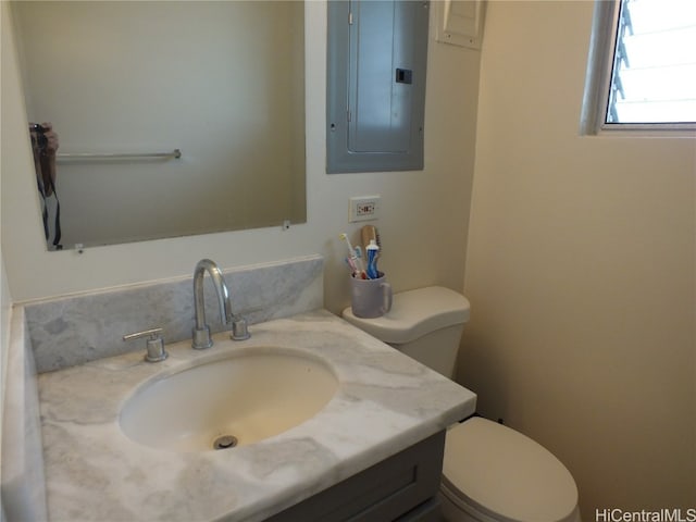 bathroom with vanity, toilet, and electric panel