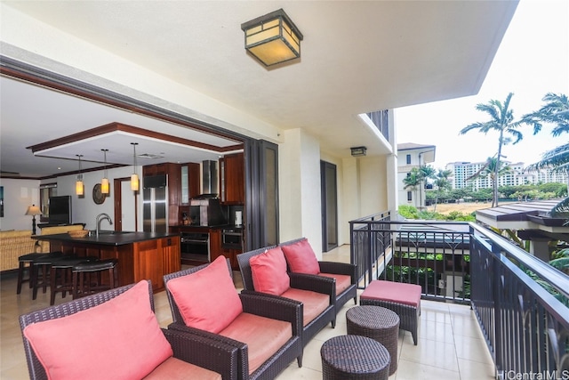 balcony featuring sink and an outdoor hangout area