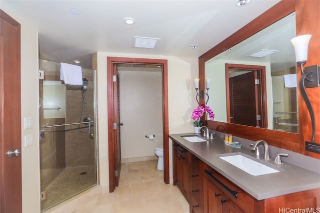 bathroom featuring vanity, toilet, tile patterned flooring, and a shower with door