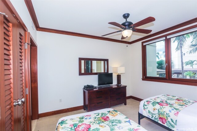 bedroom with light carpet, a closet, crown molding, and ceiling fan