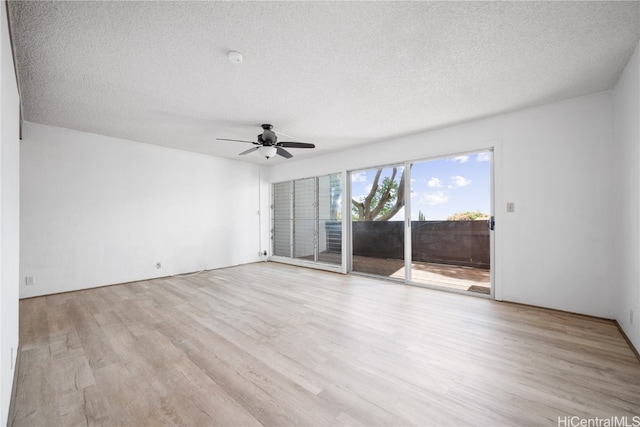 spare room featuring light hardwood / wood-style floors, a textured ceiling, and ceiling fan